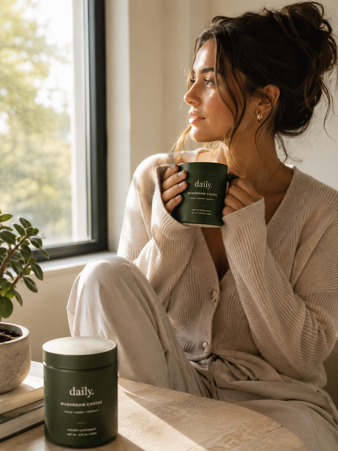 Woman with a mug of daily. mushroom coffee by a window