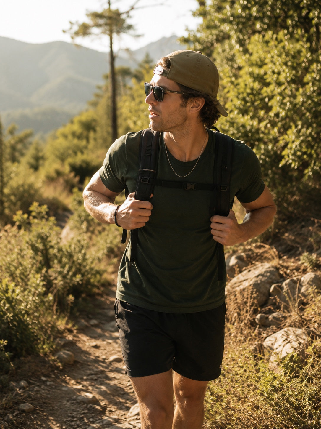Man hiking outdoors on a sunlit trail