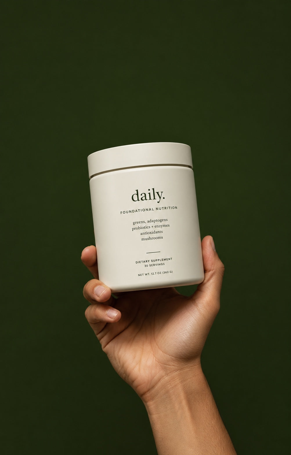 Hand holding daily. tub on a dark green background